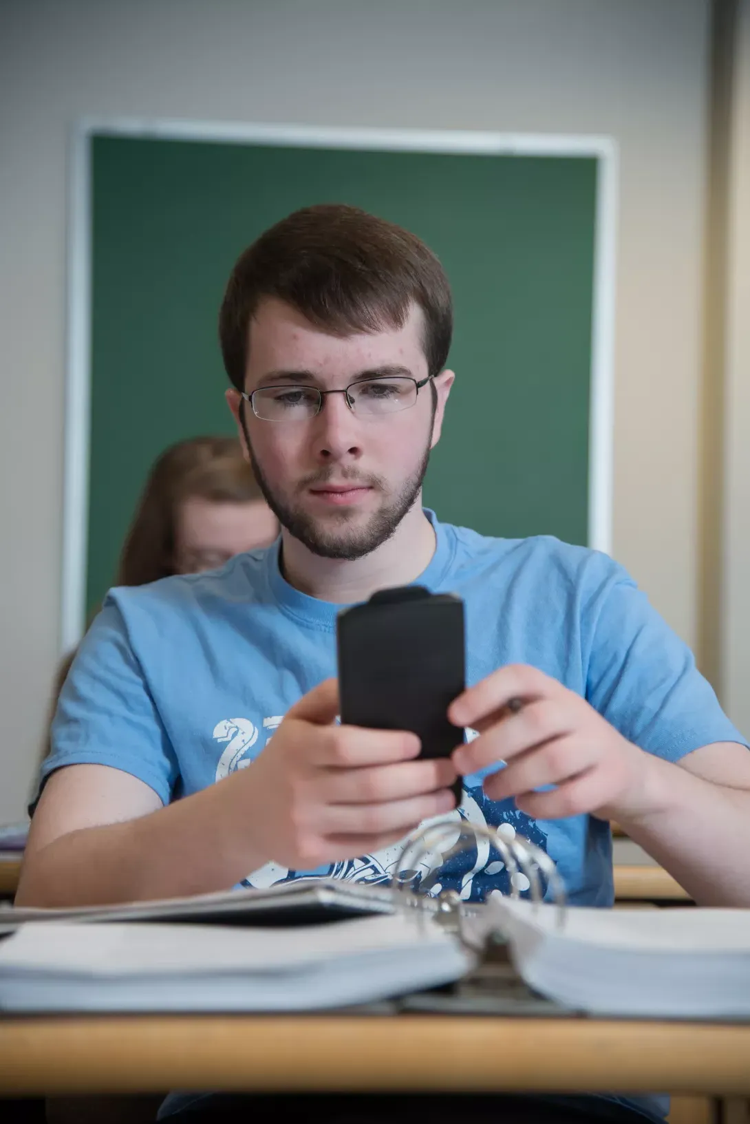 Student in math class using a calculator to solve a problem